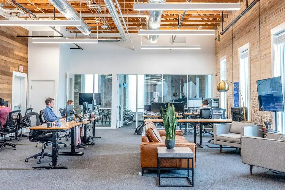 Bright open-plan office with people working at long desks